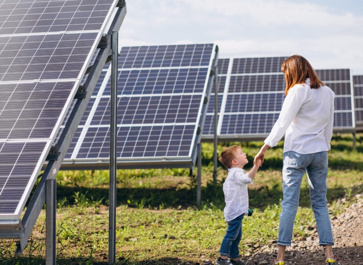 mother-with-her-little-son-by-solar-panels@2x